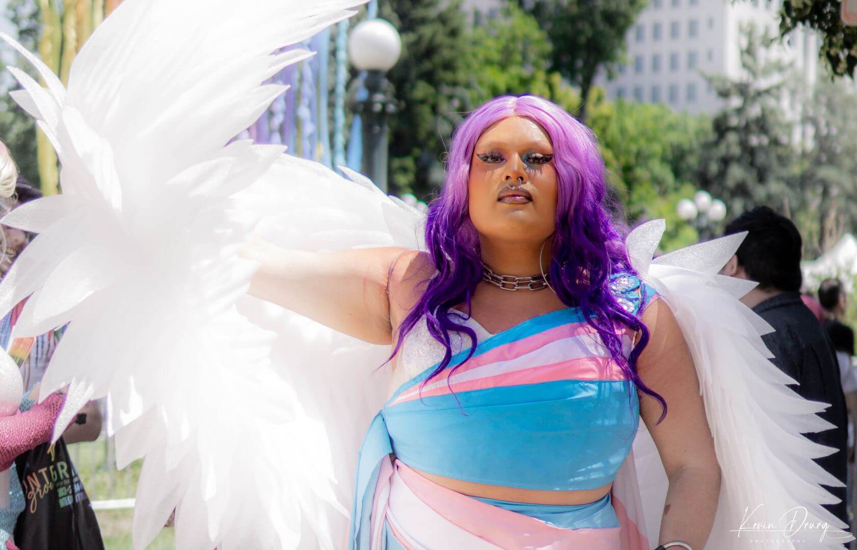 2023 Denver PrideFest – photo by Kevin Drury-31 A person wearing a transgender pride colored outfit with wings at Denver PrideFest 2023