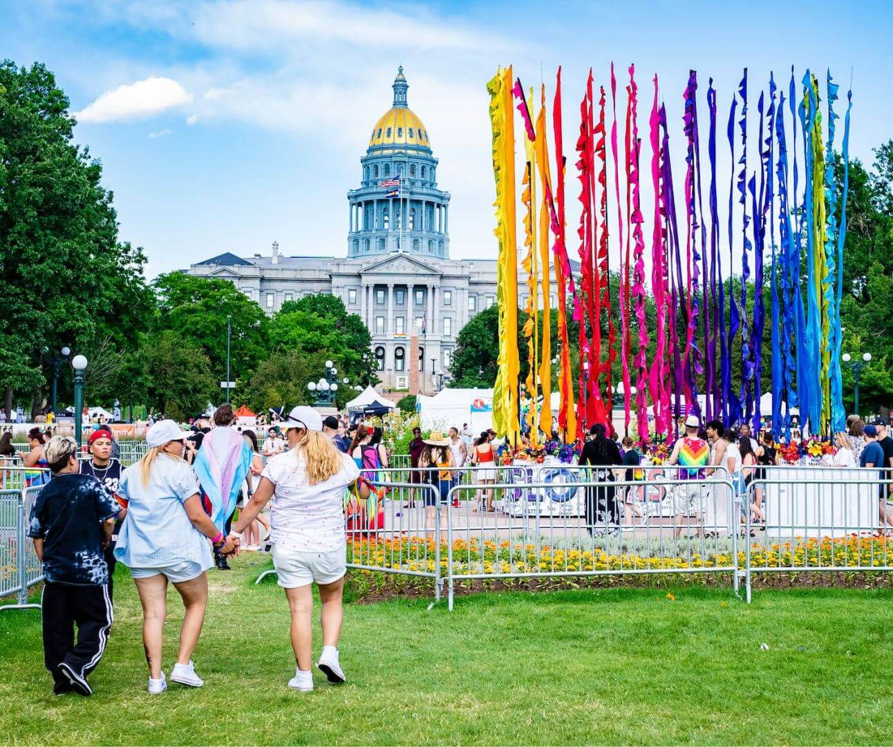 DenverPrideFest-Cropped Denver PrideFest attendees walk past the rainbow flag art installation towards the Colorado State Capitol