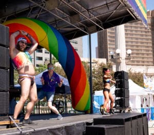 DJ Sinna-G poses for a picture with the go-go dancers on stage